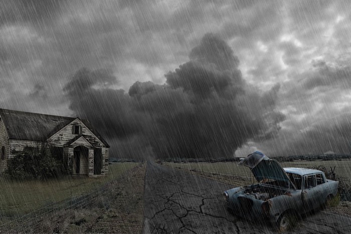 Old abandoned house and car in a storm