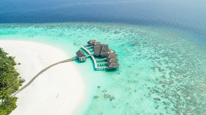 Aerial view of overwater bungalows in the Maldives