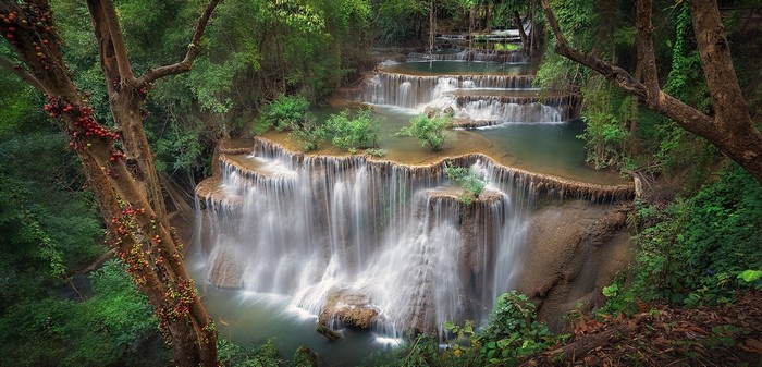 Serene Multi-Layered Tropical Waterfall in Dense Forest