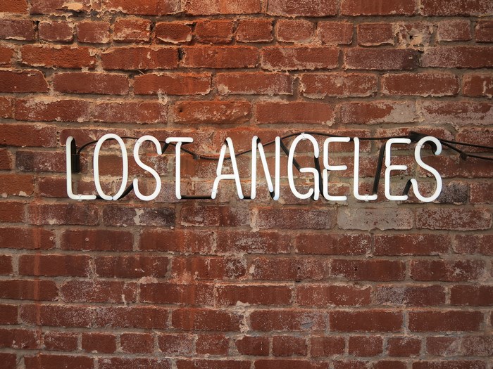 Neon sign 'LOST ANGELES' on a brick wall