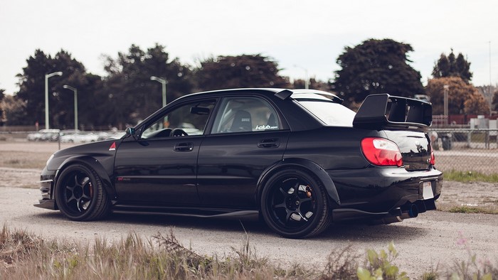 Black Subaru WRX STI with large rear spoiler