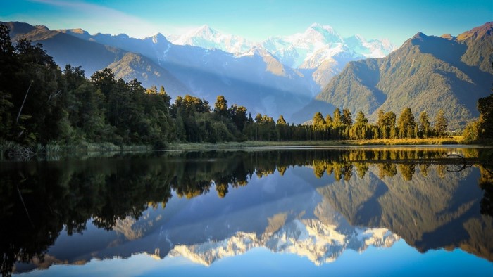 Lake Reflection of Snowy Mountains and Forest in New Zealand