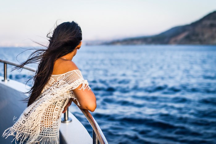 Woman on a boat looking at the sea