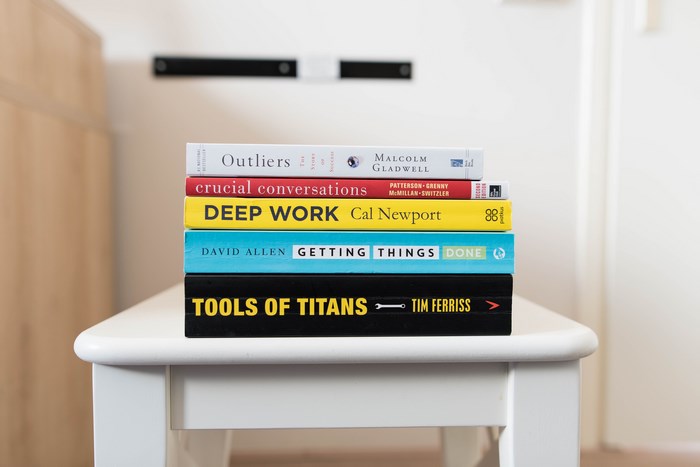 Stack of Books: Outliers, Deep Work, Tools of Titans
