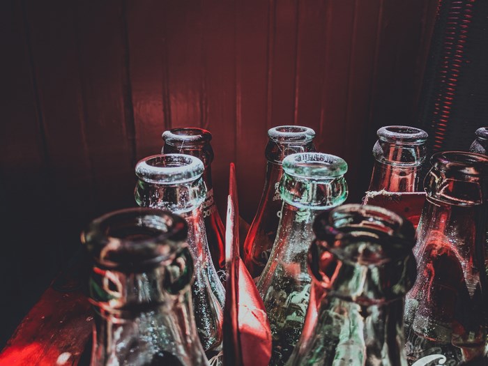 Close-up of vintage Coca-Cola bottles in a crate