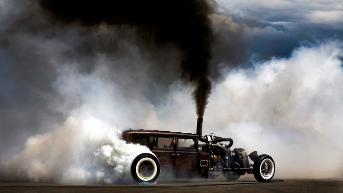 Classic car performing a smoky burnout