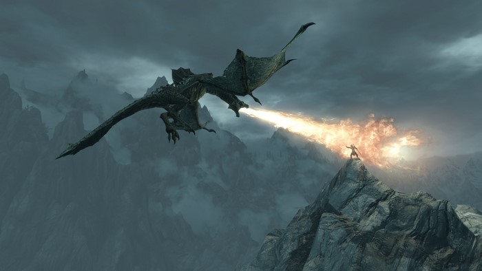 Dragon breathing fire at a warrior in The Elder Scrolls V Skyrim