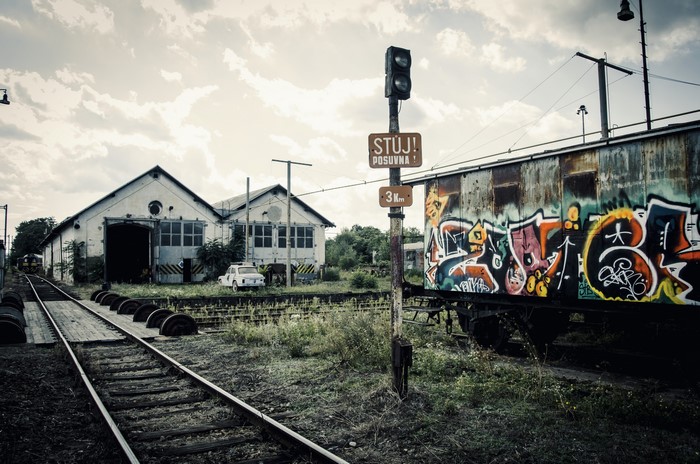 Abandoned train station with graffiti-covered train car