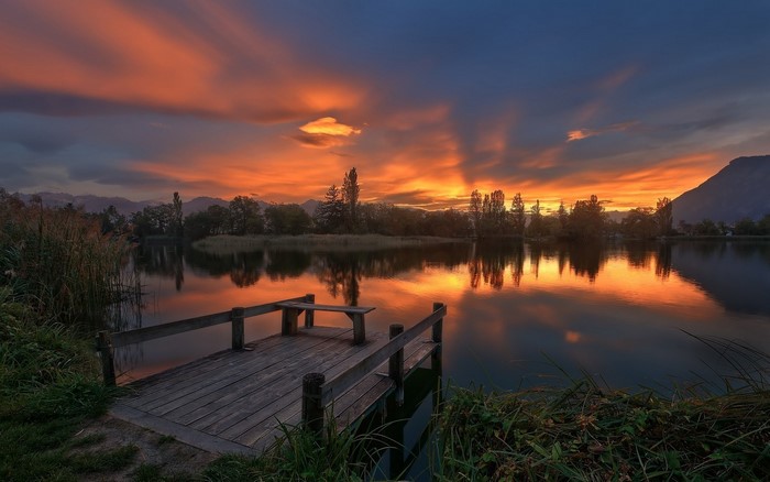 Sunset over a lake with a wooden dock