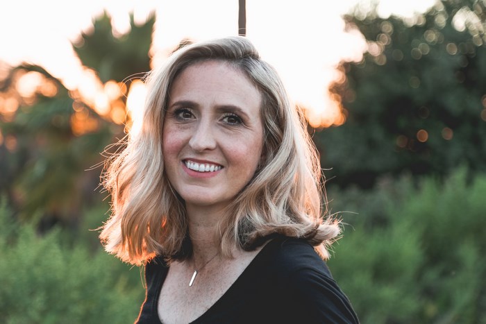 Woman smiling at sunset in a garden