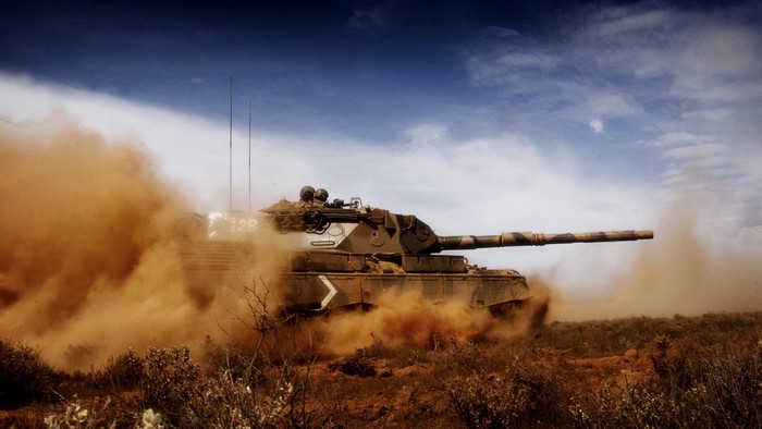 Tank driving through dust