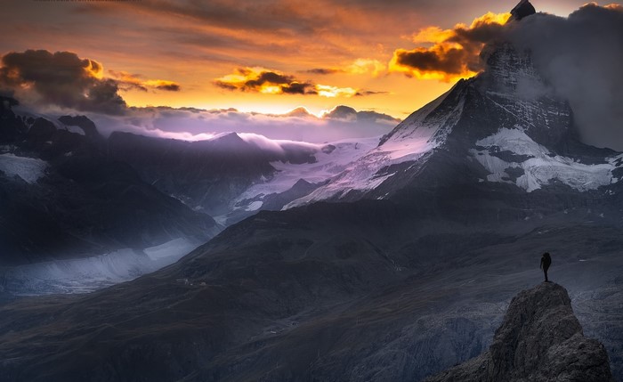Matterhorn mountain at sunset with a hiker