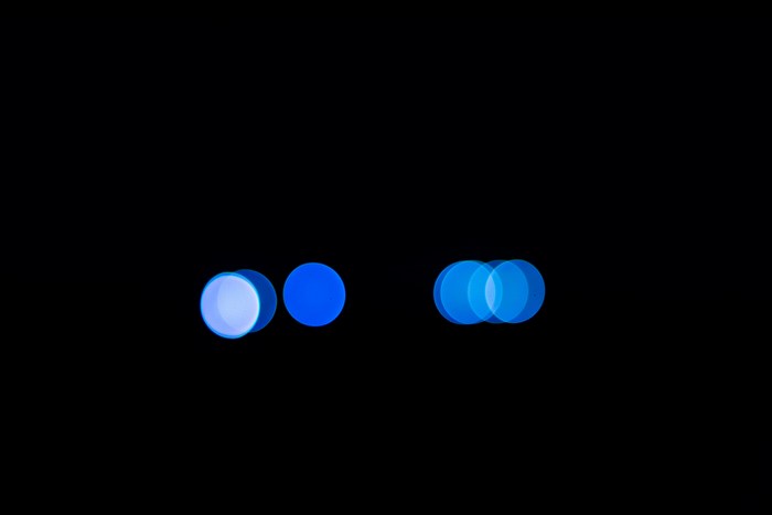 Blue bokeh circles on a black background