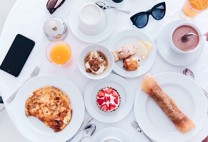 Breakfast spread with omelette, tart, and coffee