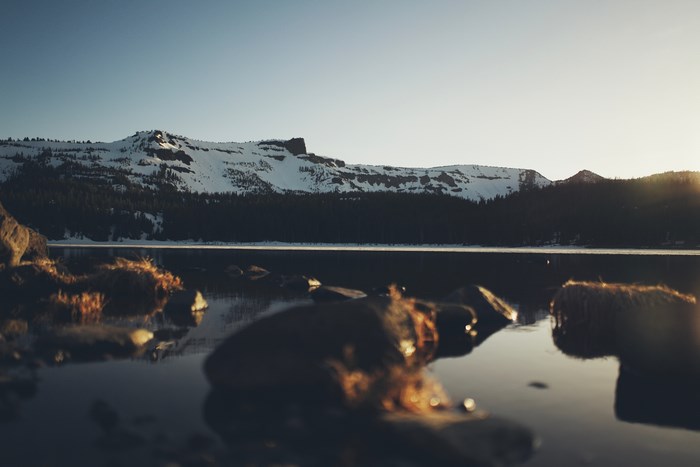 Snow-capped mountain range reflected in a calm lake