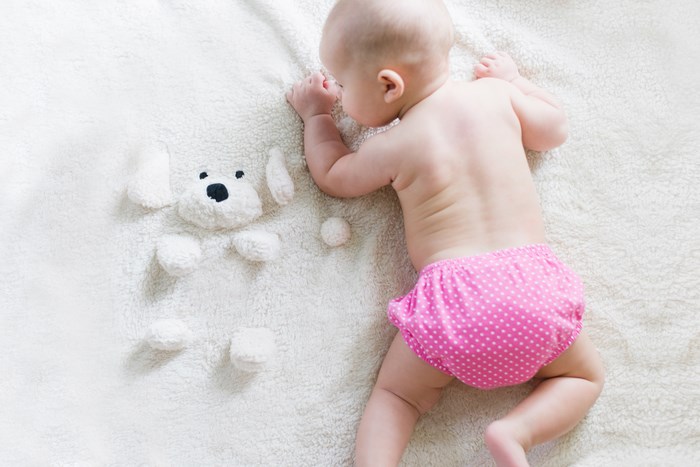 Sleeping Baby Girl in Pink Diaper on Blanket