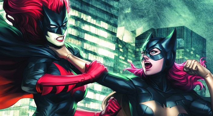 Batwoman and Batgirl fighting in a city