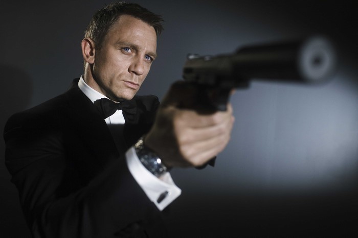 Daniel Craig as James Bond holding a gun