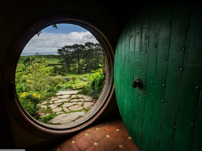 The Hobbit door overlooking a green landscape