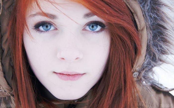 Redhead woman with blue eyes in winter coat