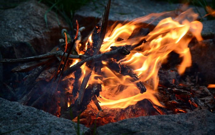 Campfire burning with wood and rocks