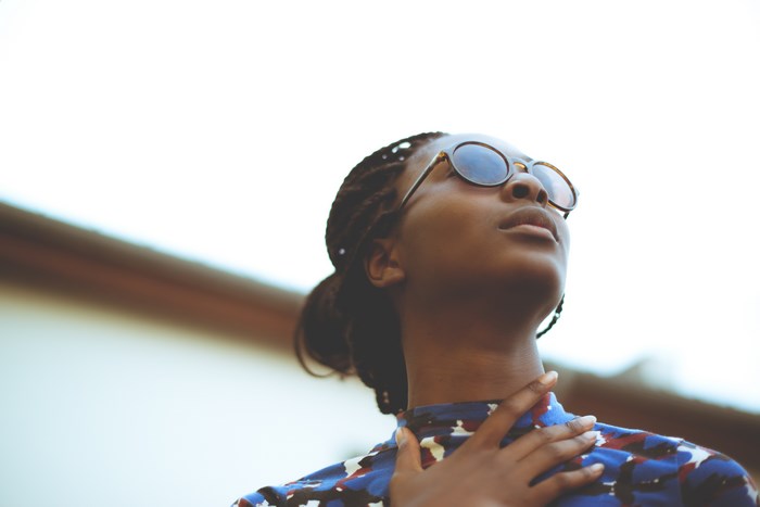 Woman wearing sunglasses and a patterned dress