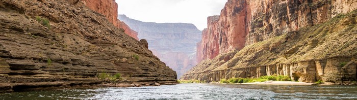 Grand Canyon River Flowing Between Rocky Cliffs
