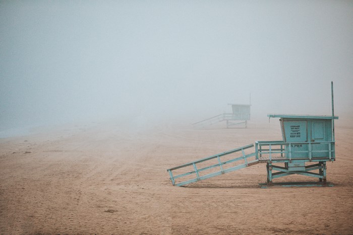 Lifeguard towers on a foggy beach