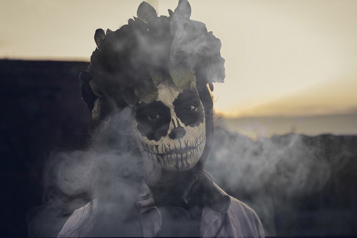 Woman with Dia de los Muertos makeup and flower crown