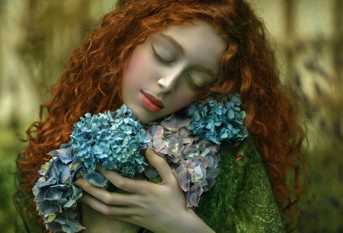 Fantasy art of a redhead woman with blue flowers