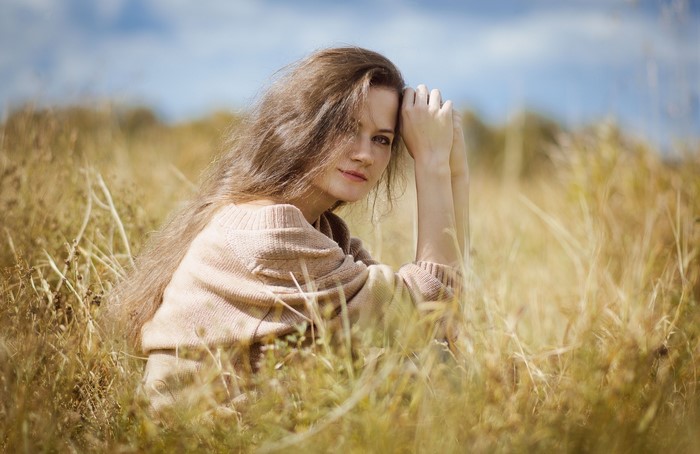 Woman sitting in a field of tall grass