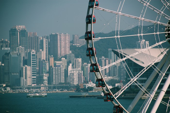 Ferris wheel overlooking Hong Kong skyline and harbor