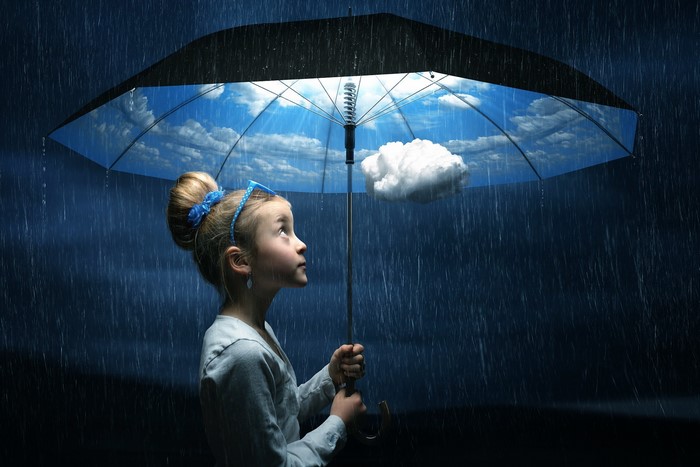 Girl under an umbrella with clouds
