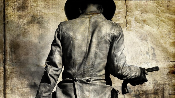Man in cowboy hat holding a gun