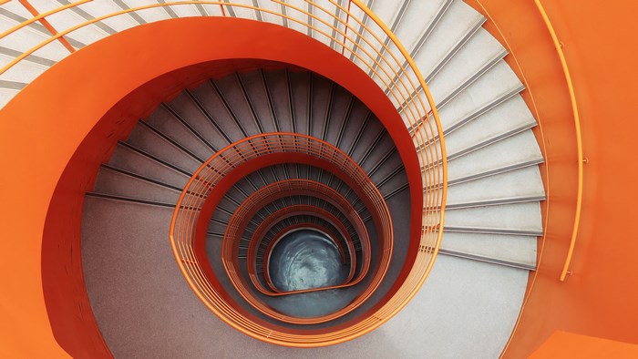 Orange spiral staircase looking down