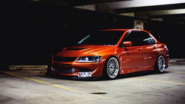 Orange Mitsubishi Lancer Evolution IX tuned car