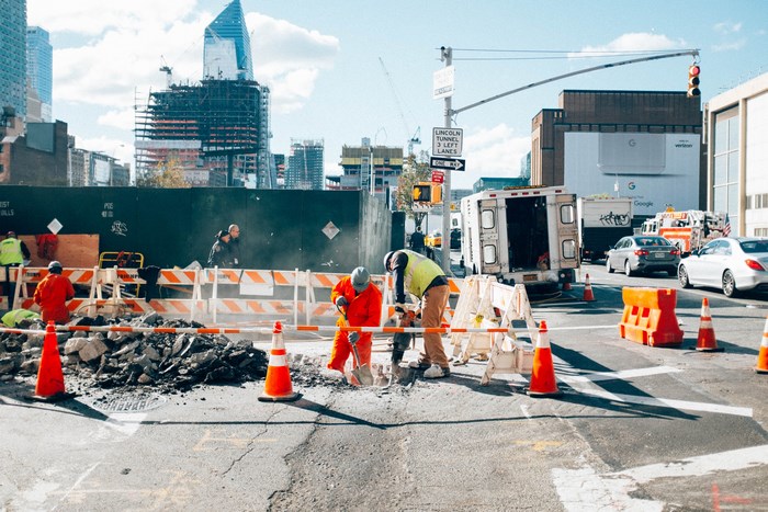 Construction workers digging on a New York City street