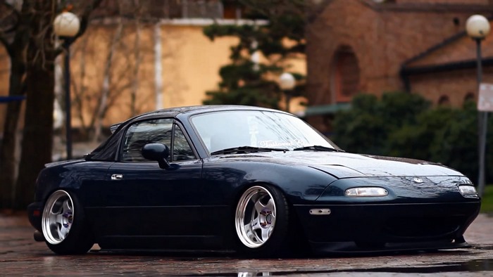 Dark blue Mazda MX-5 Miata with custom wheels