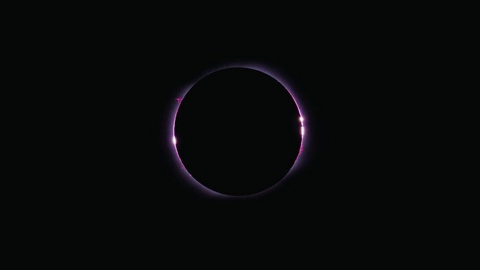 Solar eclipse with pink corona
