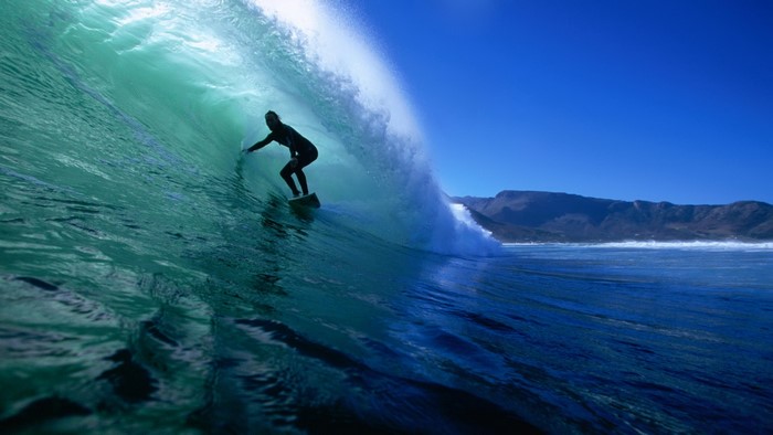 Surfer riding a wave in the ocean