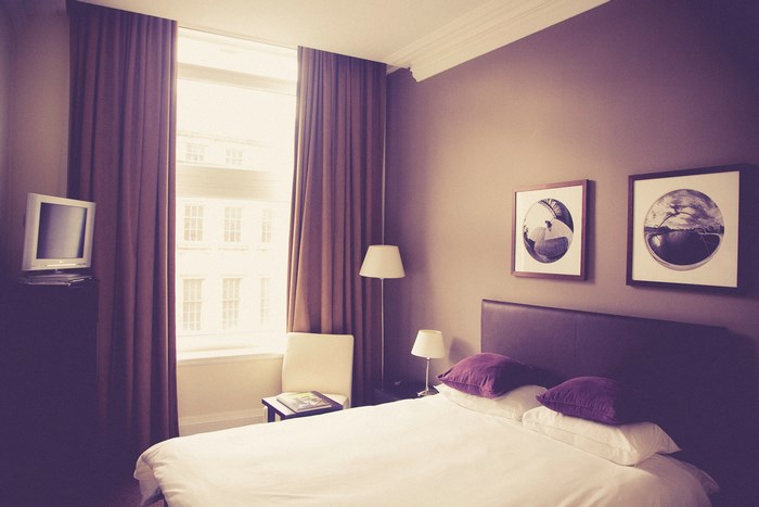 Bedroom with bed, window, and lamps