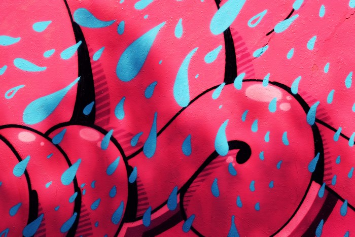 Graffiti art with pink background and blue water drops