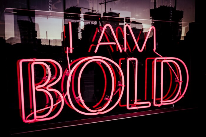 Red Neon Sign "I AM BOLD" in a Window