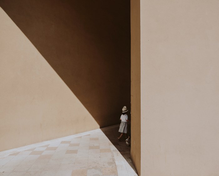 Girl walking in geometric shadows
