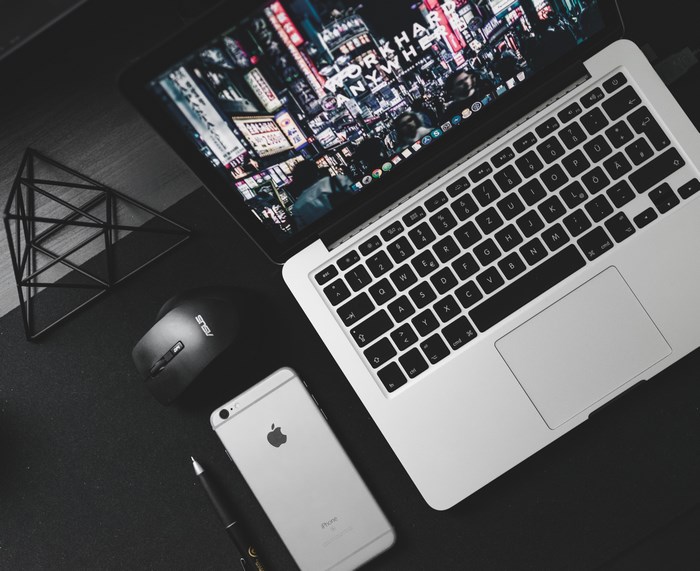 Apple iPhone, Asus Mouse, and MacBook on a Desk