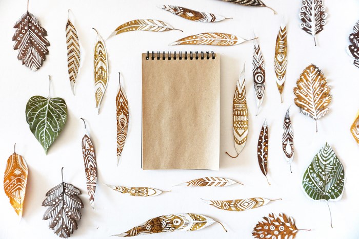 Collection of ornate leaves and a notebook