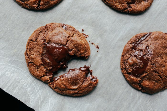 Gooey chocolate chip cookies on baking paper
