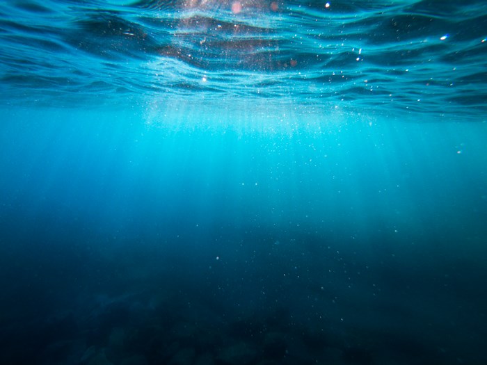 Sunlight Rays Penetrate Clear Blue Ocean Water