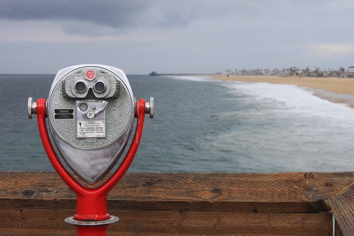 Coin-operated binocular on a pier overlooking the ocean