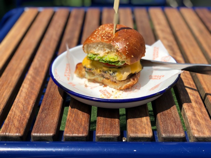 Hamburger on a plate on a wooden table